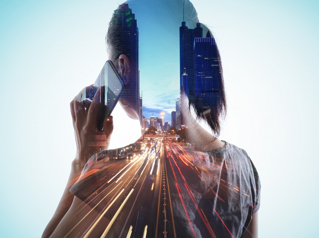Double exposure of cityscape and smart phone